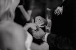 The hands of the bride and her godmothers together to encourage her