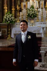 Daddy's groom helping to put on his shirt for his wedding