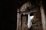 Wedding dress hanging on some ruins