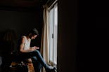 Groom writing a message to his girlfriend at the window