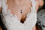 Detail of the dress and necklace of the bride