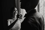 Sister of the groom smiling and putting perfume on her