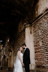 Groom and bride smiling touching their foreheads