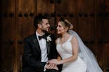 Groom and bride sitting hugging and smiling
