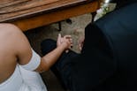 Groom and bride holding hands at their wedding