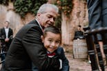 Grandfather hugging his grandson at the wedding