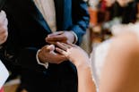 Husband putting the ring on his wife