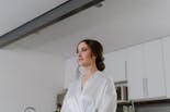 Bride watching her hairstyle and makeup for her wedding in the mirror
