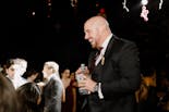 Groom peeking out the window at his wedding